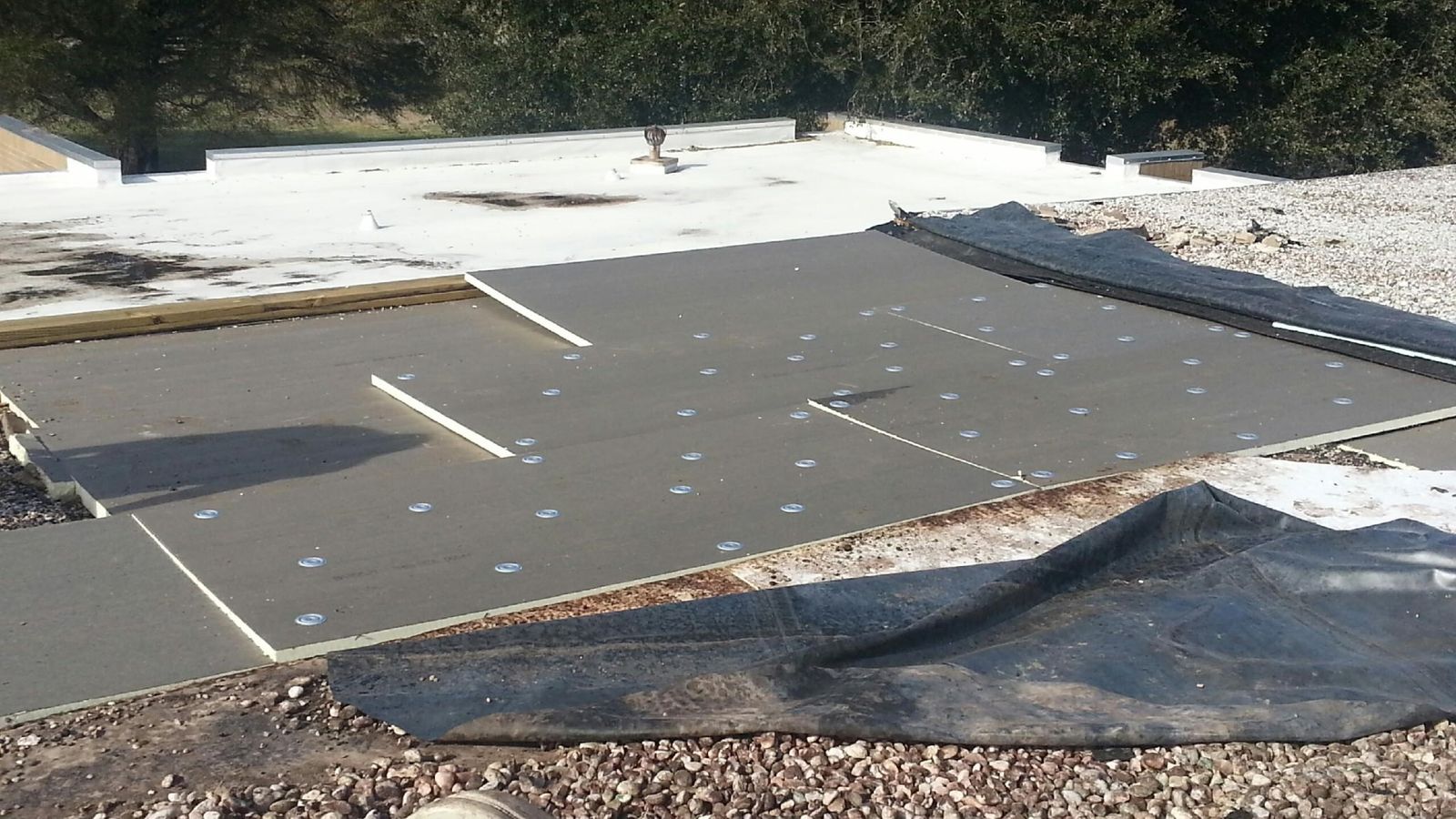 Insulation board and membrane being installed on an Atlanta commercial roof